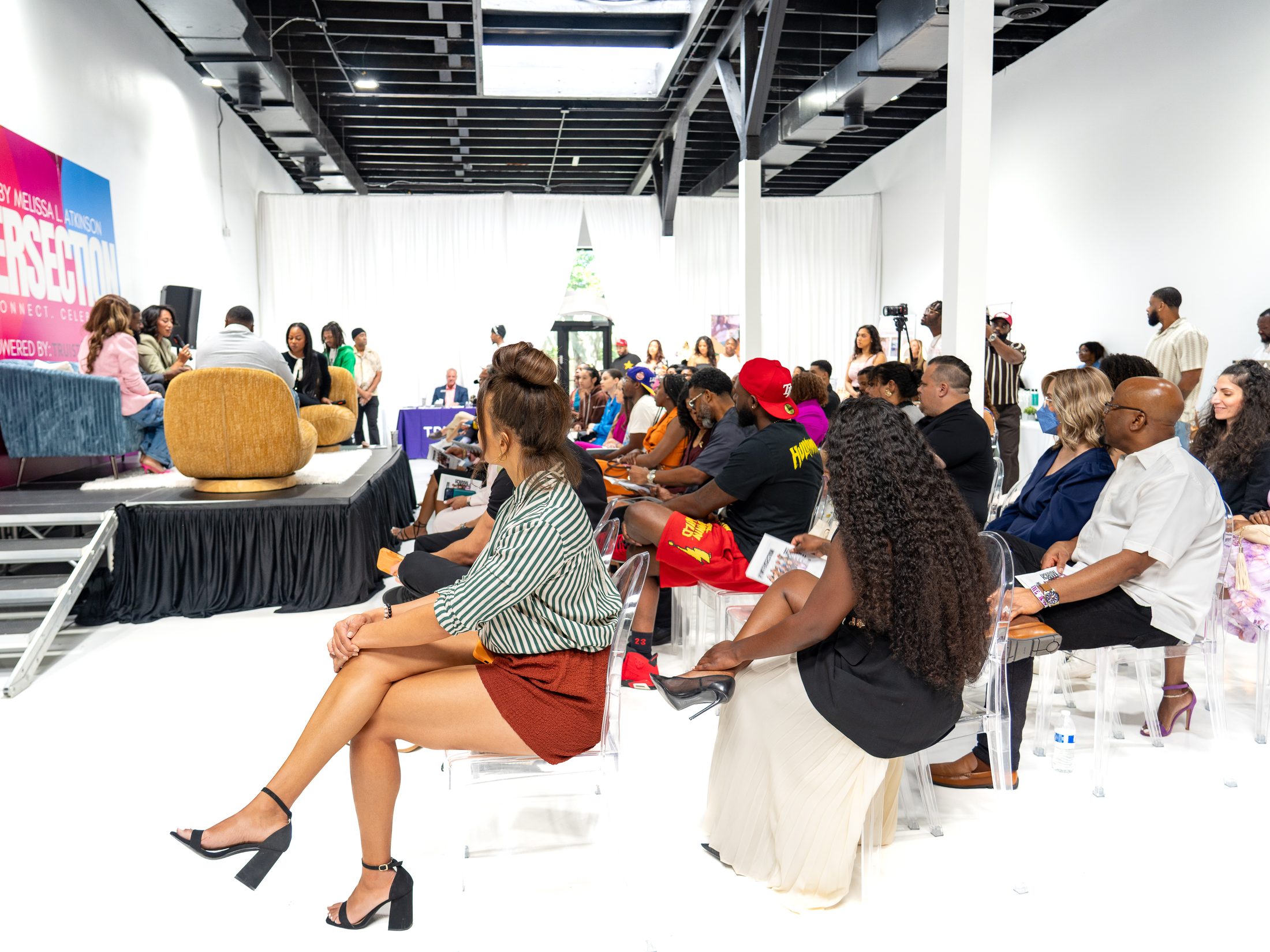 Audience seated inside a venue during a live presentation